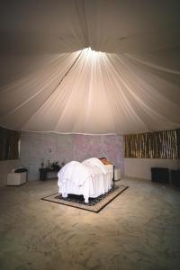 een slaapkamer met een wit bed in een tent bij Hotel Quinta Moctezuma in Oaxtepec