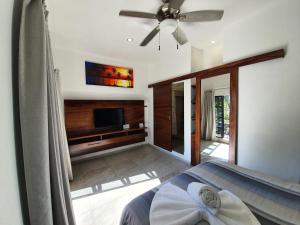 a bedroom with a bed and a flat screen tv at HOTEL OLAS ALTAS BUCERIAS in Bucer&iacute;as