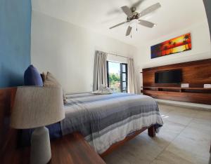 a bedroom with a bed and a ceiling fan at HOTEL OLAS ALTAS BUCERIAS in Bucerías