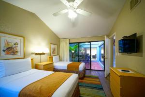a hotel room with two beds and a tv at Ventura at Boca Raton by Capital Vacations in Boca Raton