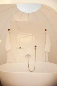 a bathroom with a bath tub with a shower at Green Land Bubble Glamping in Cabarete