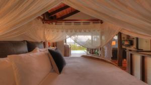 - une chambre avec un grand lit et des rideaux blancs dans l'établissement Montville Misty View Cottages, à Montville 82 autres photos