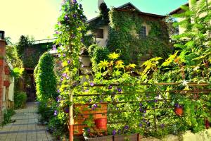 a building covered in lots of plants and flowers at 1-линия Апартаменты in Gelendzhik