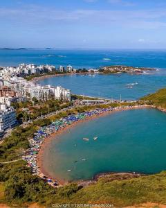 an aerial view of a beach with a crowd of people at Paraíso Peracanga - Bacutia in Guarapari
