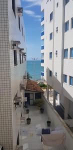 a view of a balcony between two buildings at Paraíso Peracanga - Bacutia in Guarapari