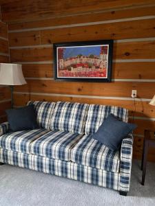 a couch sitting in a living room with a wall at Bye the Bay Bed and Breakfast in Ridgetown
