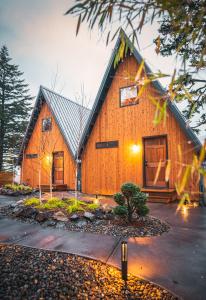 a large wooden house with a gambrel roof at Artbliss Hotel in Stevenson