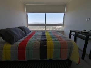 מיטה או מיטות בחדר ב-Panorámico Viña del Mar