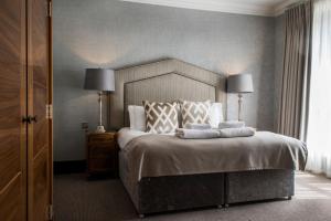 A bed or beds in a room at Kinnettles Hotel & Spa 