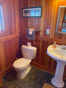 a bathroom with a toilet and a sink at Whistling Winds Motel in Lincoln City
