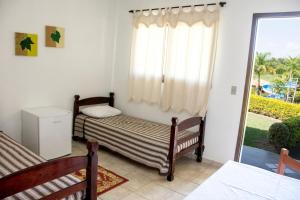 Łóżko lub łóżka w pokoju w obiekcie Hotel Fazenda Monte Sião