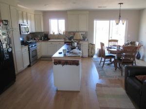 a kitchen and living room with a counter and a table at Peaks Wildernest House Bed and Breakfast - Vaccinations Required in Flagstaff +1 photo