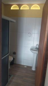 a bathroom with a sink and a toilet at casa morada da praia in Xeréu