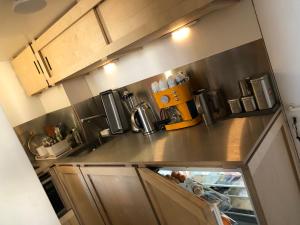 a kitchen with a stainless steel counter top at duplex top central Marais in Paris