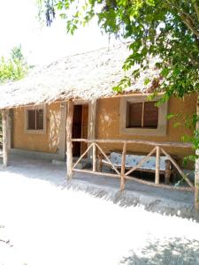 a small house with a straw roof at Room in BB - Mida Creek Eco Camp community project,Mida Creek Watamu Kilifi County 