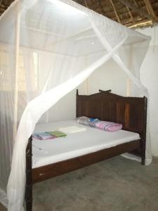 a bedroom with a bed with a canopy at Room in BB - Mida Creek Eco Camp community project,Mida Creek Watamu Kilifi County 