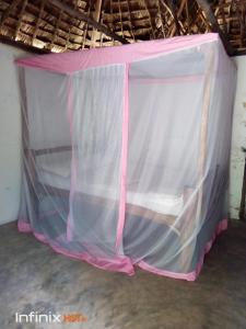 a pink and white tent in a room at Room in BB - Mida Creek Eco Camp - relax in cosy cottage 