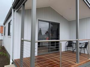 a porch with a chair and a table on a house at Portland Holiday Village in Portland