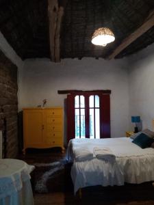 a bedroom with two beds and a dresser and a window at Estancia El Sol in Sogamoso