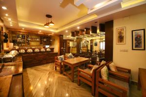 a restaurant with a table and chairs and a bar at Hotel Middle Path & Spa in Pokhara