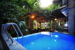 a swimming pool in the middle of a yard at Hotel Middle Path & Spa in Pokhara
