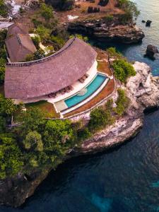 an aerial view of a building on an island in the water at Villa Tanjung in Nusa Lembongan