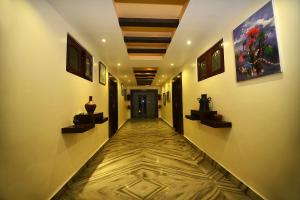 a long hallway with paintings on the walls at Hotel Middle Path & Spa in Pokhara
