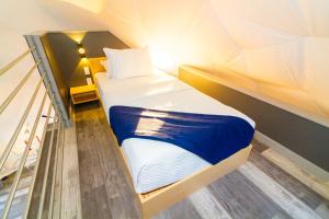 A bed or beds in a room at Udoscape Glamping Resort