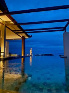 a view of the ocean from a swimming pool at night at Kayangan Boutique Hotel in Sanur