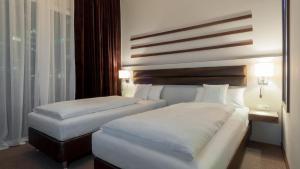 Postel nebo postele na pokoji v ubytování Hotel Nordhausen
