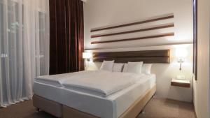 Postel nebo postele na pokoji v ubytování Hotel Nordhausen