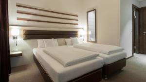 Postel nebo postele na pokoji v ubytování Hotel Nordhausen