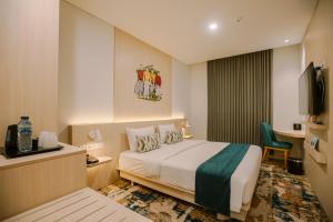 Letto o letti in una camera di Cordia Hotel Yogyakarta - Hotel Dalam Bandara