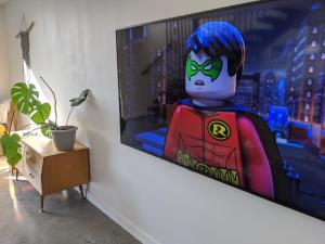 a lego lego superhero is on a tv screen at A home away from home in Inverloch