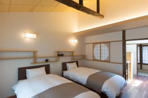 Un pat sau paturi într-o cameră la Rikyu-an Machiya House
