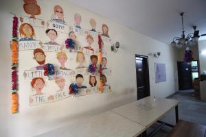 a wall with pictures of people on it at The Desire Hostel in New Delhi