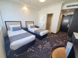 Burke and Wills Hotel Toowoomba客房内的一张或多张床位