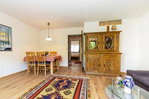 a living room with a couch and a dining room at Ferienwohnung Kothen in Reit im Winkl