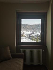 a window in a room with a view of a city at La Stua Livigno in Livigno