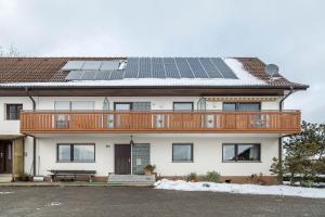 a house with solar panels on the roof at Ferienwohnung Gebhart in Öhningen