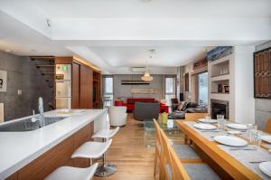 a kitchen and living room with a long dining table at Kitanishi 3 by H2 Life in Kutchan