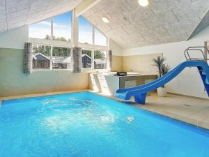a indoor swimming pool with a water slide at 16 person holiday home in Hasselberg in Kappeln