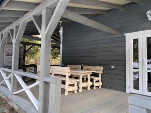 a wooden deck with a table and chairs on it at Дзембронія in Dzembronya