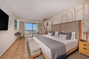 a large bedroom with a large bed and a balcony at Secrets Lanzarote Resort & Spa - Adults Only (+18) in Puerto Calero