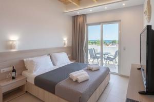 a hotel room with a bed with towels on it at Bivalvia Studios in Faliraki