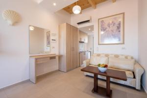 a living room with a couch and a table at Bivalvia Studios in Faliraki +103 photos
