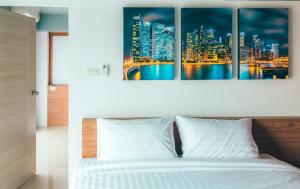 a bedroom with a bed with a city skyline at PP@Hotel Rangsit in Pathum Thani
