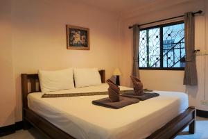 sypialnia z łóżkiem z dwoma ręcznikami w obiekcie My Mum Home, SHA Plus Certified w mieście Chiang Mai