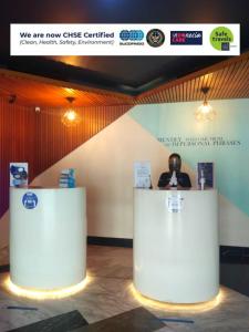 a stage with a white counter with a person behind it at Kyriad Fatmawati Jakarta in Jakarta