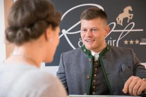 a man talking to a woman in front at Wander und Aktiv Hotel Rösslwirt in Lam